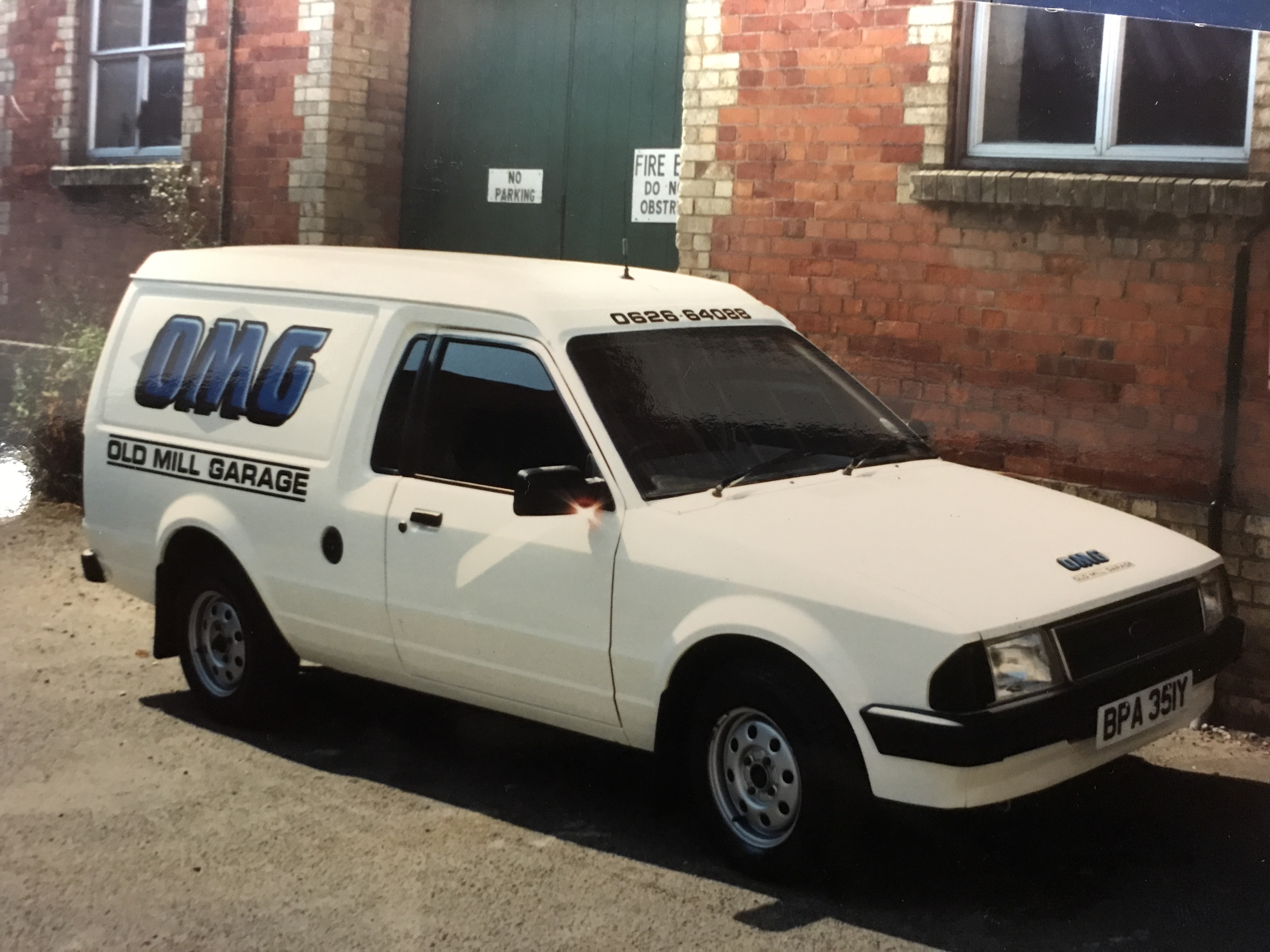 White mini bus with ultra blue lettering and grey watermarks , created in Torquay