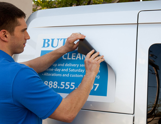Newton Abbot Magnetic Vans Signs being applied to a vehicle